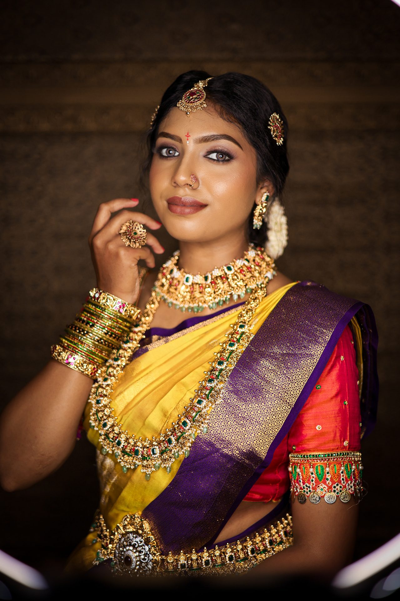 South Indian bride in yellow and purple Kanjivaram silk with temple jewellery and gajra — shot by Aura Pixels Studio
